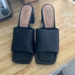 Black heeled sandals.